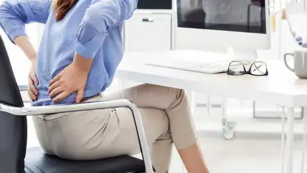 Side view of proper seated posture at a desk